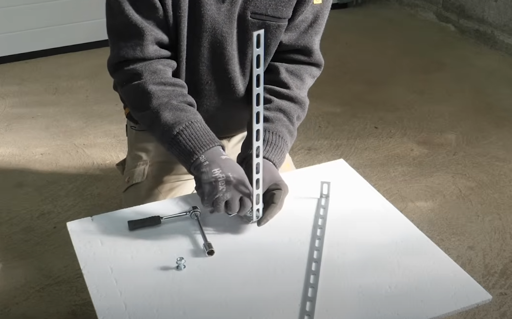 Technician repairing a garage door track with precision tools, showcasing expert garage door track repair services in Sarasota, FL.