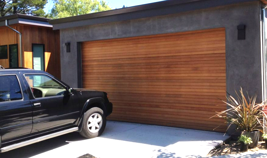 Professional technician providing same-day garage door repair services in Sarasota, FL, inspecting and fixing a residential garage door.