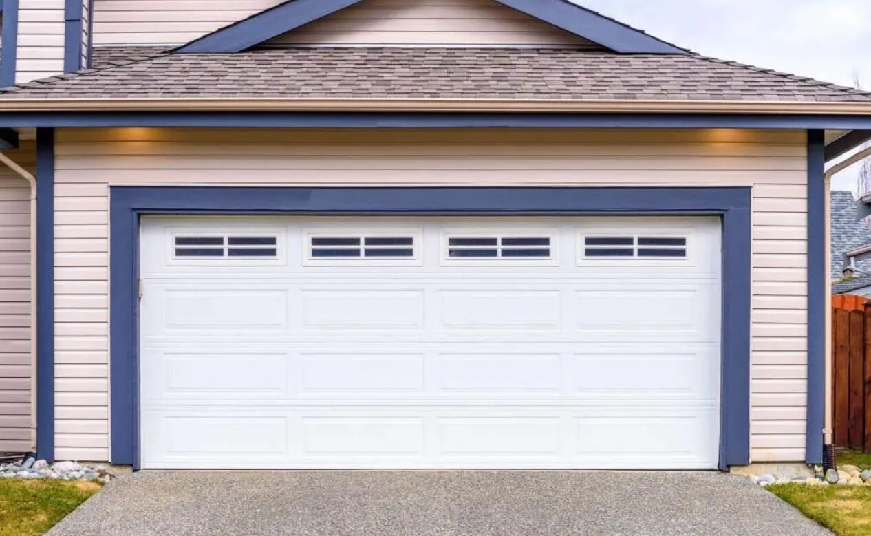 Technician providing same-day garage door repair services in Sarasota, FL, fixing a residential garage door with professional tools.