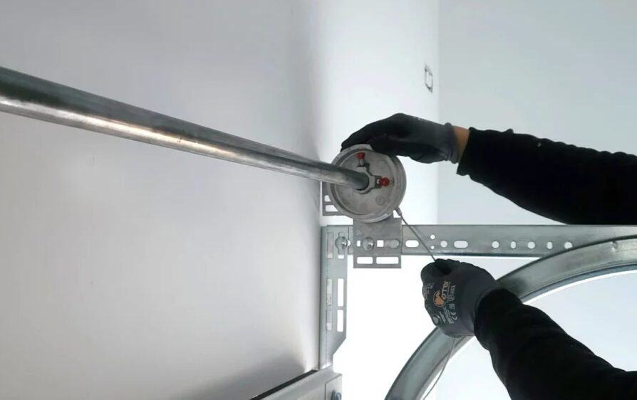 Technician performing garage door cable repair in Sarasota, FL, ensuring smooth and safe garage door operation.