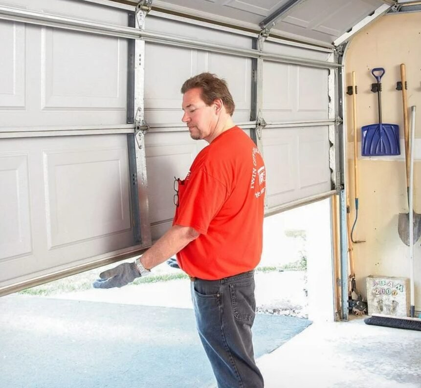 Technician performing a garage door replacement in a residential home in Sarasota, FL, showcasing professional local garage door repair services