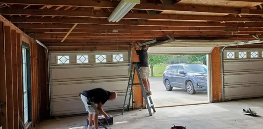Technician performing a professional garage door installation in Sarasota, FL, showcasing high-quality local garage door repair services.