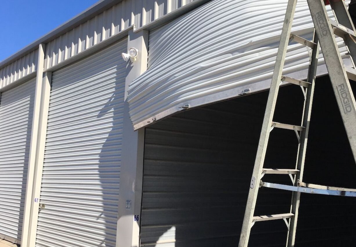 Technician inspecting a commercial garage door.